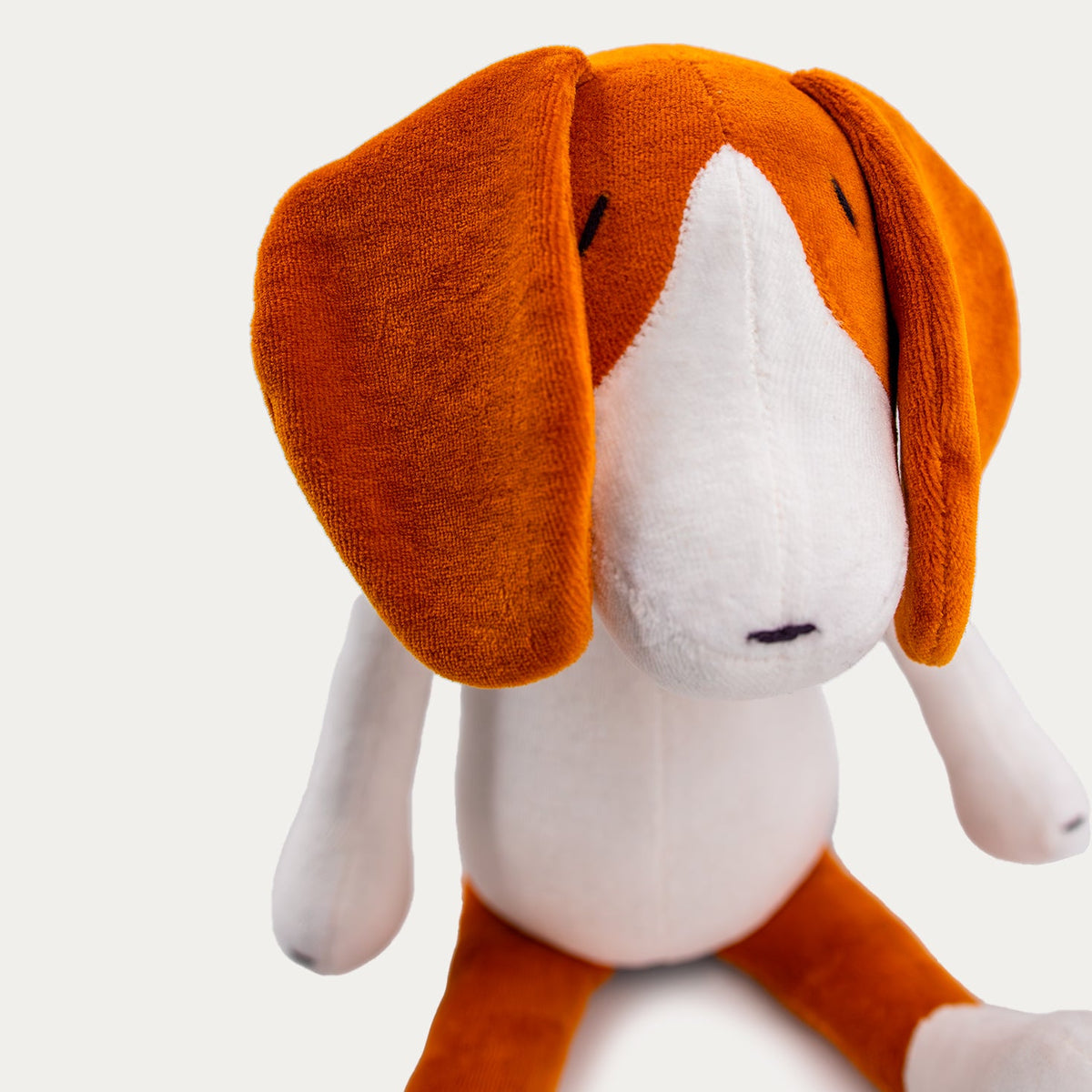 Close-up detail of stuffed beagle plush fabric and stitching