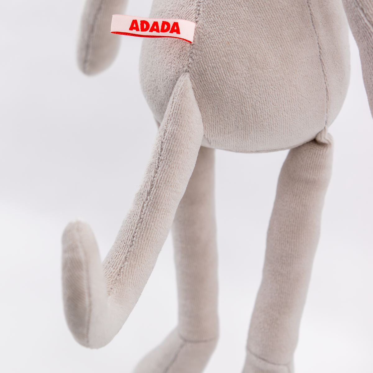 Close-up detail of stuffed greyhound plush fabric and stitching