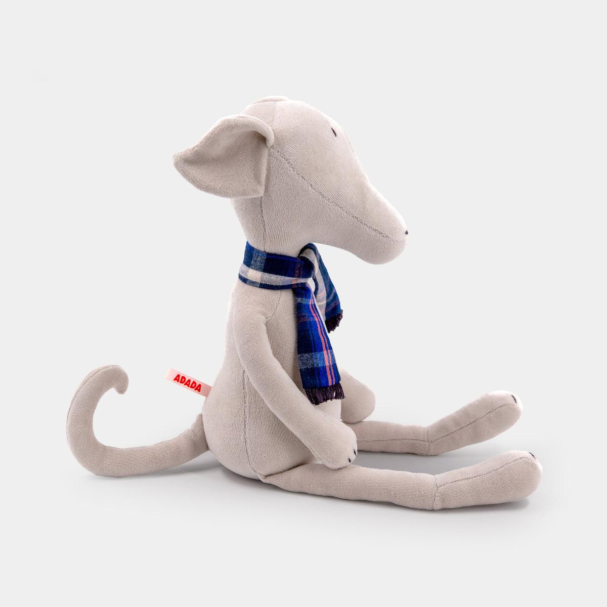 Stuffed greyhound plush, seated side profile