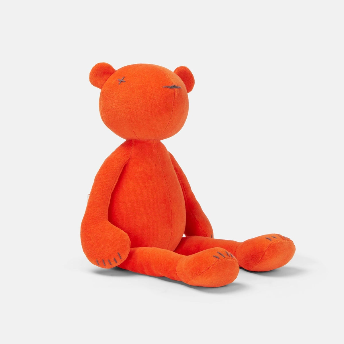 Jermaine the stuffed teddy bear plush, orange, close-up view
